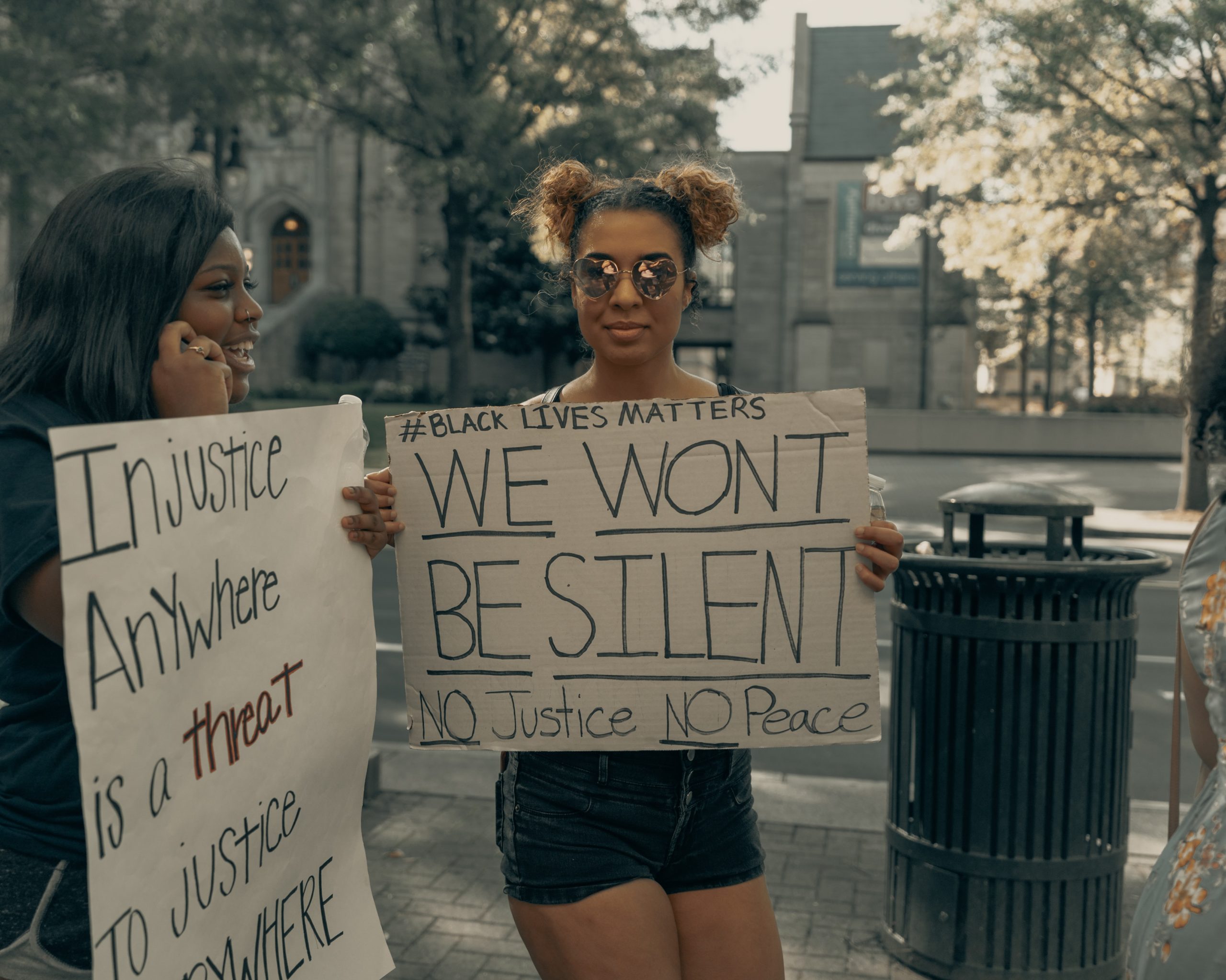 Two black women holding Black Lives Matter signs